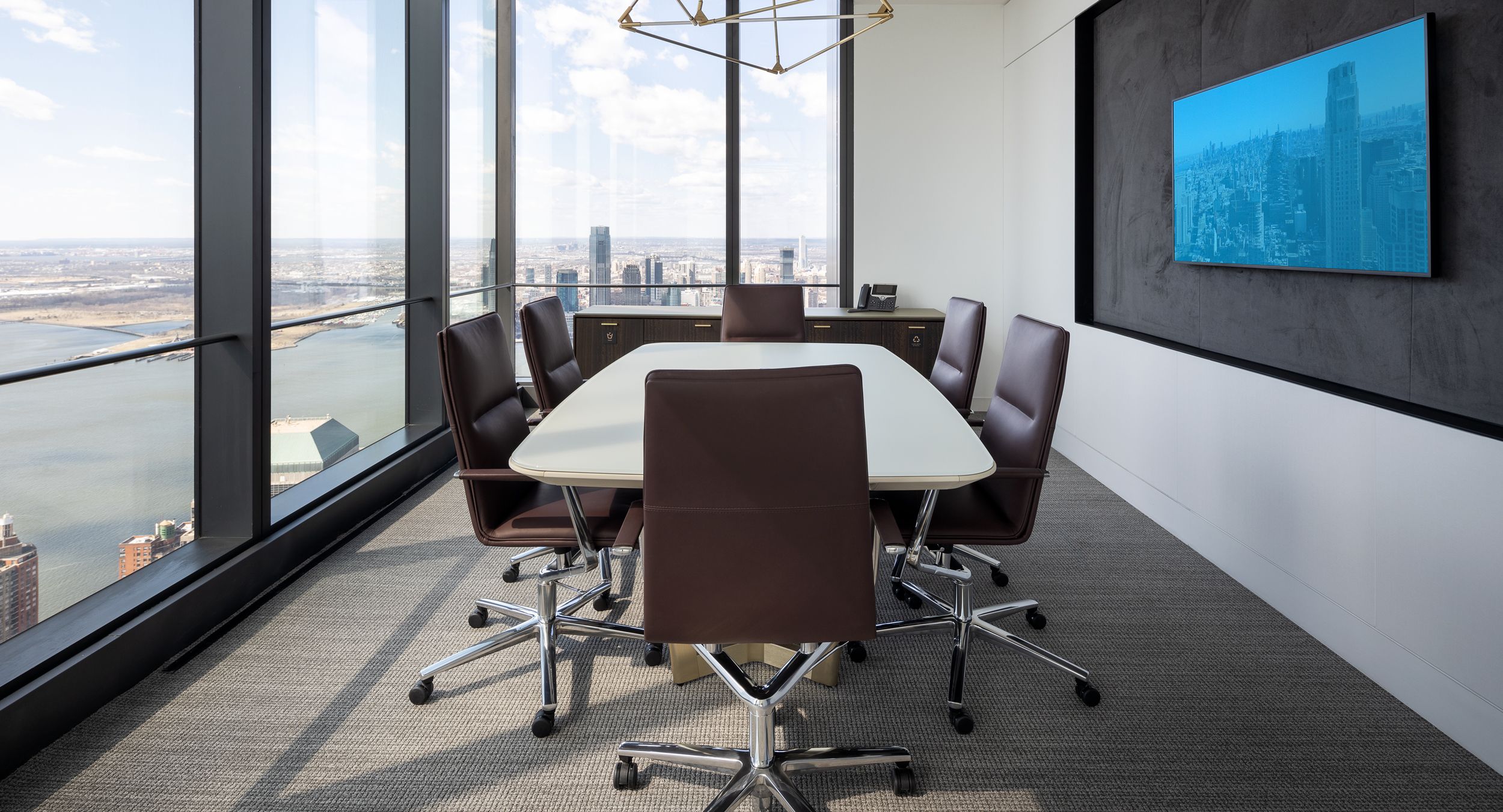 A soft boat-shaped HALO table and matching credenza elevates the clean lines of this meeting space.